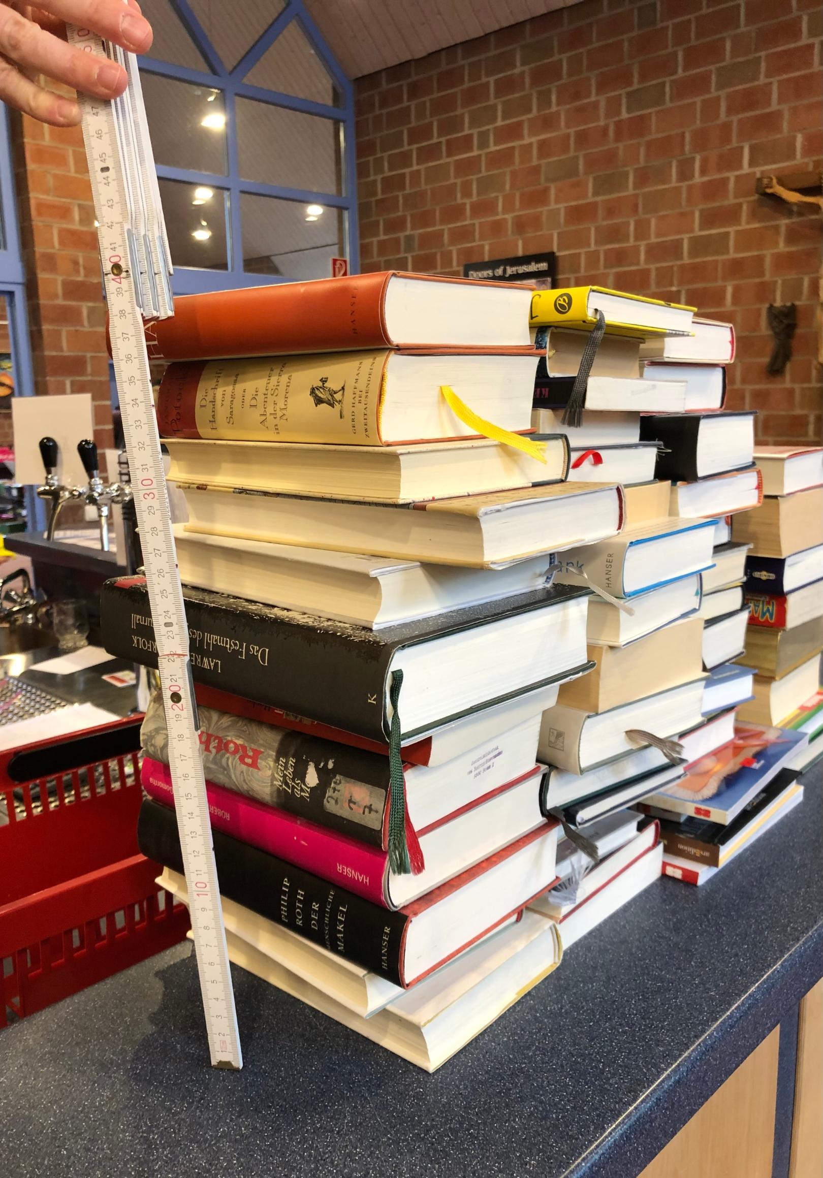 Bücherstapel wird gemessen. (c) Roswitha Briem